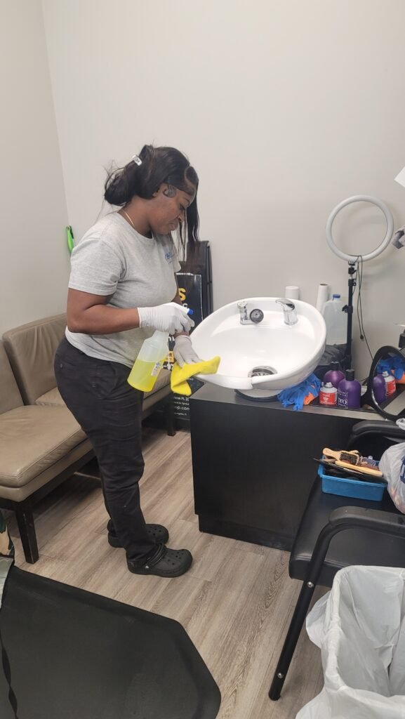 Gloved hand holding a spray bottle